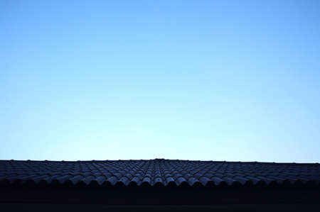 The roof of the house in the sunset the sky is blue.の写真素材