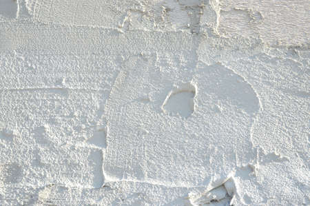 white texture cement plaster wall background, surface of exterior building wall with light in right.の写真素材