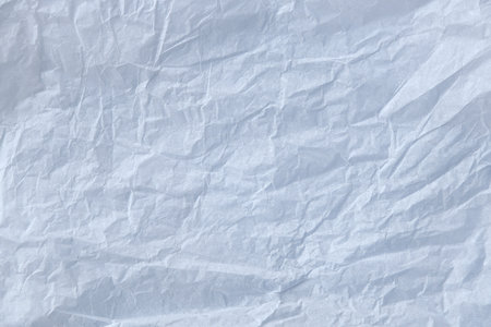 Crumpled white wax or stencil paper is used for background texture. Baking paper sheet isolated on...