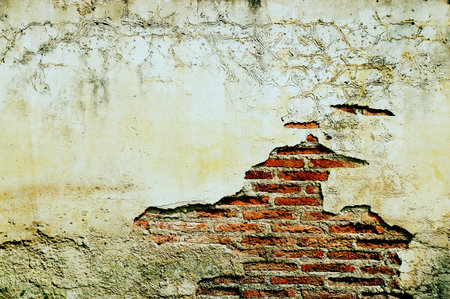 Old brick wall for background. Weathered broken brick texture use as background.の写真素材