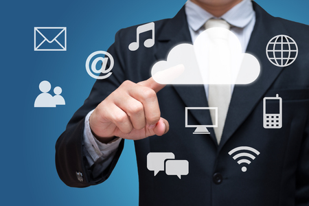 Businessman hand touch cloud computing network isolated on blue backgroundの写真素材