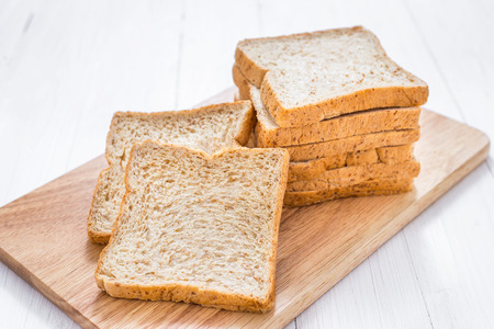 Sliced bread on white wooden table