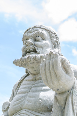 Chinese god sculpture with white backgroundの写真素材