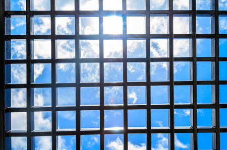 Steel rectangular mesh panel overlooking the blue sky day with sunshineの写真素材