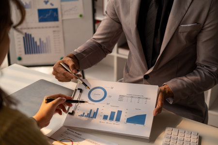 Closed up of business team male and female talking about figure, young business team working together at officeの写真素材