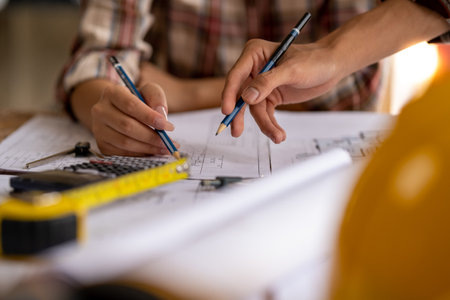 engineer are helping to design work on blueprints, engineer people meeting working and pointing at a paper, professional engineer and architect are drafting a constuction house room buildingの写真素材