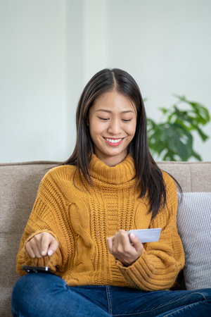 Happy smart young woman Asian using smartphone for shopping, mobile shopping, beautiful woman doing...