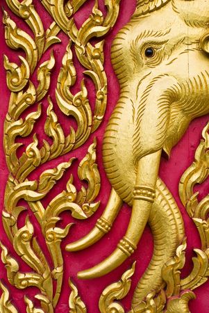 elephant carved gold paint on church doorの写真素材