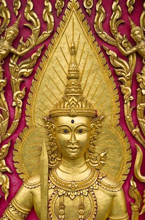 Buddha carved gold paint on church doorの写真素材