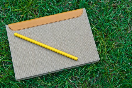 brown books on the grassの写真素材