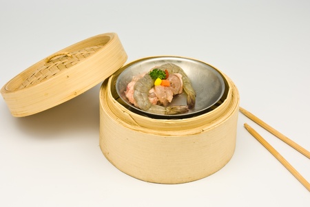 Chinese steamed shrimp dimsum in bamboo containers traditional cuisineの写真素材