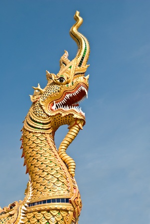 king of naga with blue sky at thai templeの写真素材