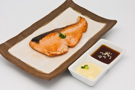 Salmon fish grilled in the plate on white backgroundの写真素材