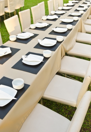 Dinner place setting. A white plate with stainless fork and cupの写真素材