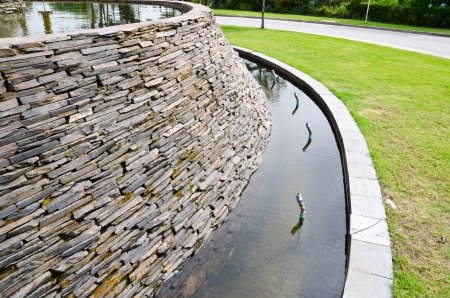 Decorative fountain wall with a slate stone in the gardenの写真素材