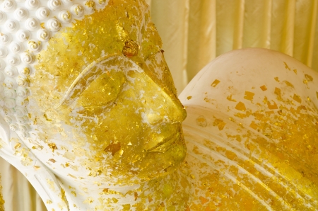 Sleeping white Buddha statue with gold leaf  in Thailandの写真素材