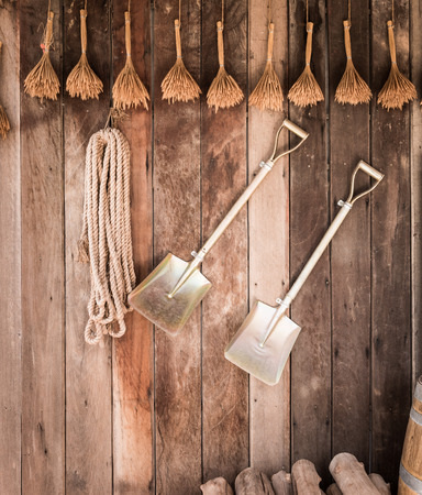 close up Two shovels of an old country house on vintage wooden wallの写真素材
