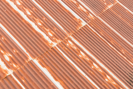 close up a rusty corrugated iron metal sheet texture of old roof on building