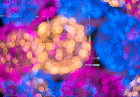 Abstract circular light bokeh New Year Festive background of defocused decorated xmas tree bokeh...