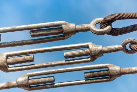 close up steel turnbuckle and sling steel in construction site on a blue sky backgroundの写真素材