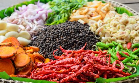 top view of various spices and herbs. turmeric, ginger, bergamot, paprika, dried peppers, garlic,...
