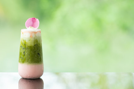 Close up of delicious juicy fresh milk green tea  on glass table Blurred leaf reflection backgroundの写真素材