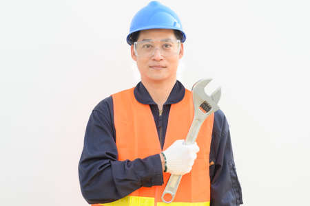 Service and engineering concept. Man hold adjustable wrench  tool on white background.の写真素材