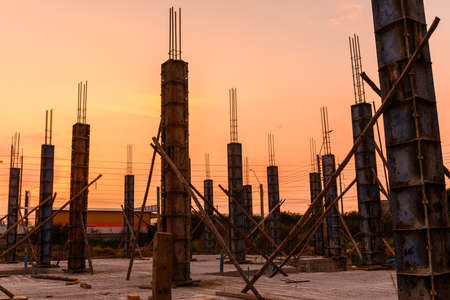 silhouette of a house column in construction site on  housing project at sunsetの写真素材