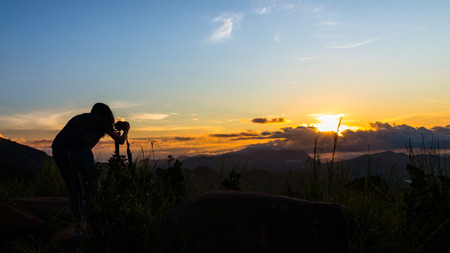 A woman photographer shot a beautiful mist in the morning as  the sun rises in the rainy season.の写真素材