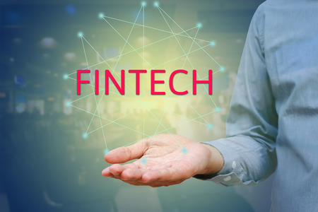 Financial and Technology (FinTech) concept. Businessman show text FINTECH on hand and networking.の写真素材