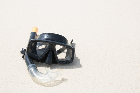 Diving mask and snorkel on sand at phuket thailand beach.の写真素材