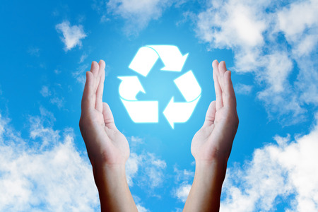 Asian young hand holding recycle  icon and nature clouds and sky background.の写真素材