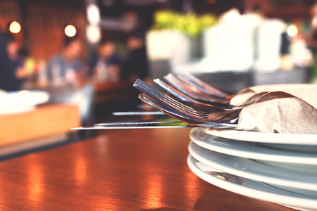 Close up fork and knife on dish in restaurant.の写真素材