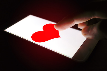 Valentines Day concept, person sending heart red message for lover.の写真素材