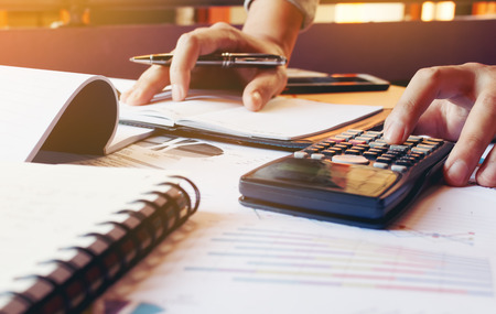 Young man calculate finance about expenses in home office.の写真素材