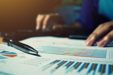 Pen on paperwork with woman calculate cost at home office.の写真素材