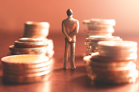 Miniature people standing with stack coin about financial and money savings concept.の写真素材