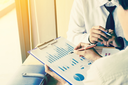 Businessman pointing the results on paperwork let colleagues view and analyze together in company.の写真素材