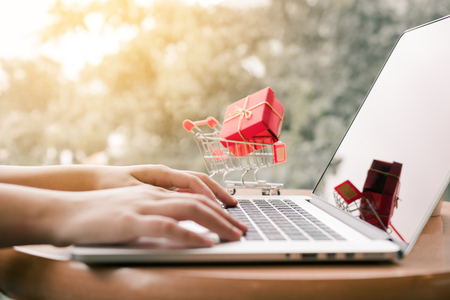 Online shopping concept with woman hand typing computer keyboard.の写真素材
