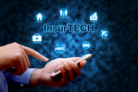 Insurance technology (Insurtech) concept, Human hand using smartphone.の写真素材