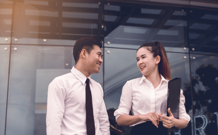 Two business people talking together at office building.の写真素材