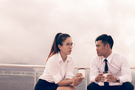Two employee sitting and talking about work.の写真素材