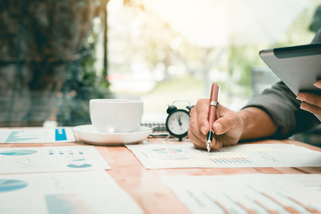Businessman writing make note on desk office and analysis business corporate.の写真素材