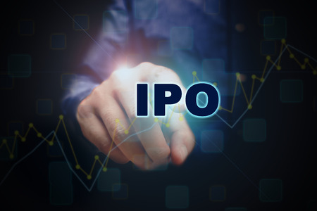 Close up finger pointing into the ipo text with initial public offering concept.の写真素材