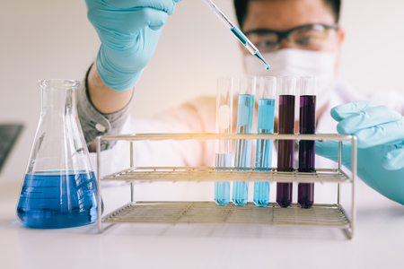 Scientist researching working with chemical fluid with using dropper in a test tube in the laboratory.の写真素材