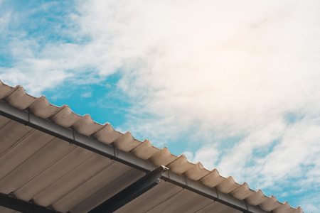 Roof tiles and blue sky with cloudsの写真素材