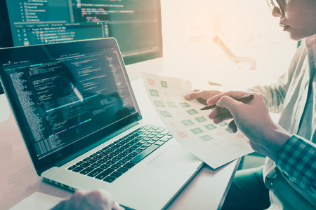 Two people coding code program programming developer computer web development coder working design software on desk in office.の写真素材