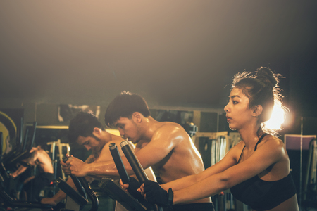 Fitness gym with people in health club.の写真素材