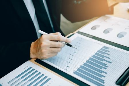 Close up of hand investors are using calculators to calculate the company's earnings to invest in stocks for future profits.の写真素材