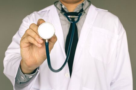Male doctor holding stethoscope.の写真素材
